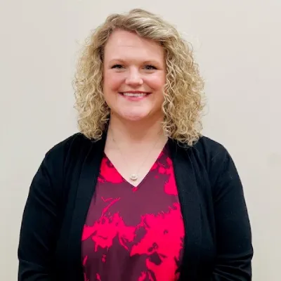 A woman with blonde hair and a red shirt.