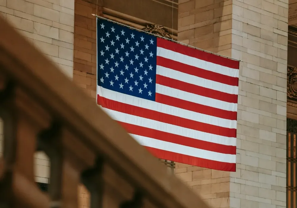 A flag hanging from the side of a building.